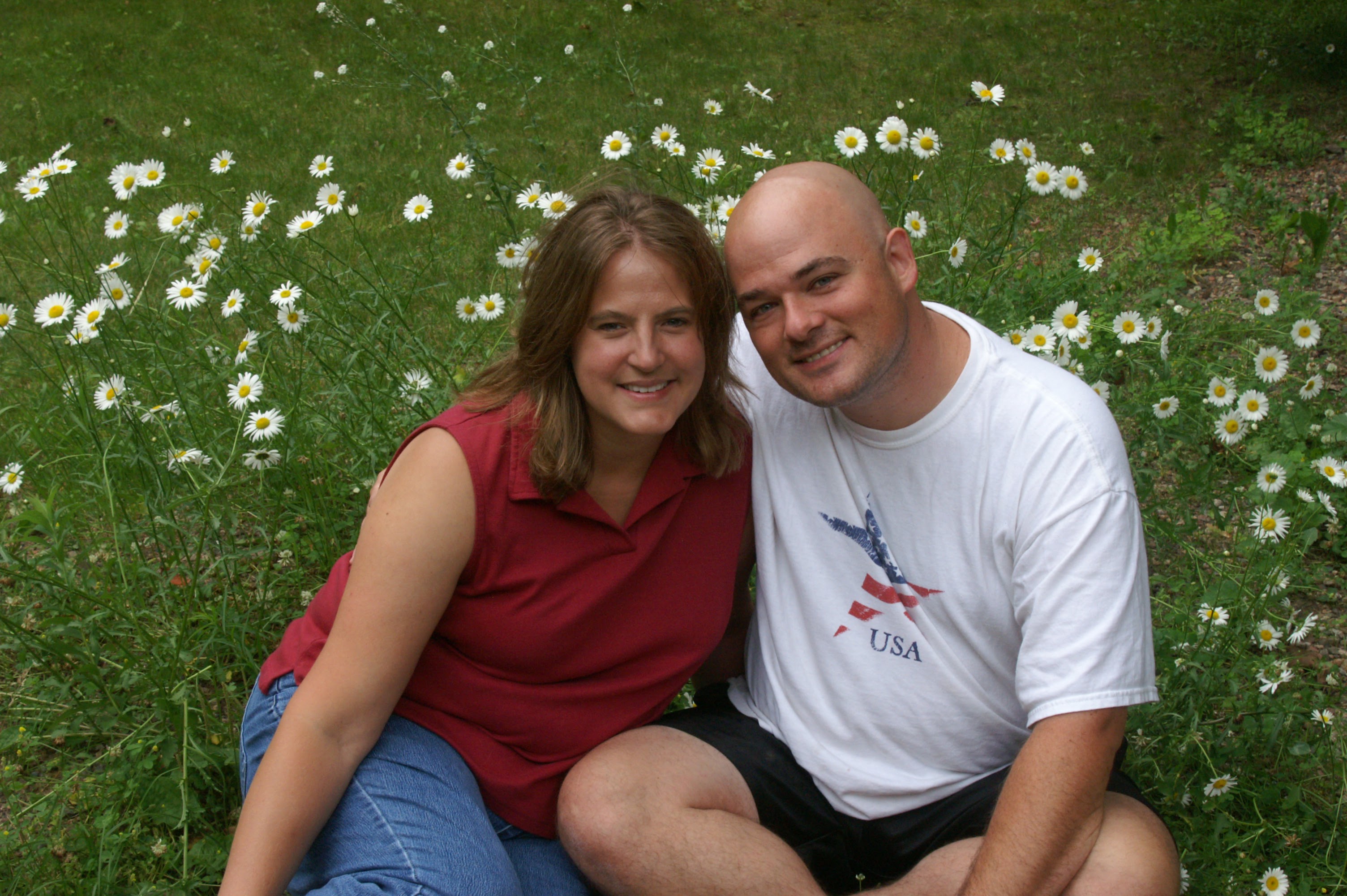 Britta and Matthew Brossard sitting together on a lawn on Independence Day, July 4, 2010